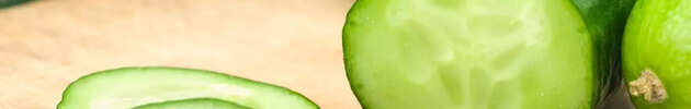 sliced-up-cucumbers-on-wooden-board-picture-id182888377